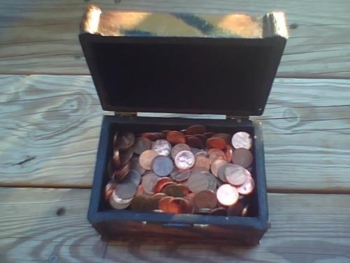 A penny saved is a penny earned !!! - Treasure chest filled with money.