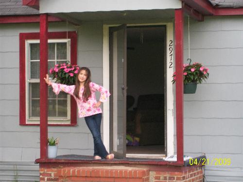 Our Now House - This is a picture of my daughter standing in front of our house now. The one we have to move from.