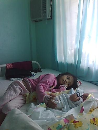 Sleeping Baby with Older SIster  - I am taken care by my older sister.