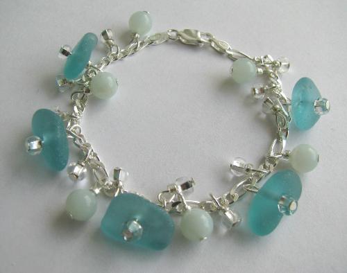Breaking Waves Aqua Sea Glass Bracelet - 5 beautiful and rare piece of soft aqua sea glass adorn this 7 ' strling silver bracelet. The authentic sea glass is accented by 6mm Amazonite beads,in a pale aqua and smaller clear glass beads. The colors remind me of breaking waves in the early am light.