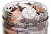 Make money - Jar of change coins filling a glass jar which symbolizes saving money; shows that it all adds up