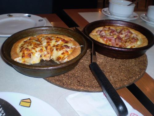 Pizza - Pizza, one is partially eaten ,the other still intact, from 'pizza hut'