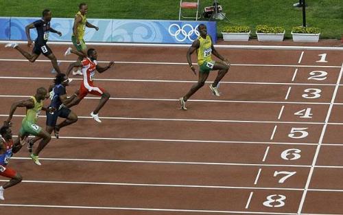 Lightning Usain Bolt - The King of Sprints, at his blitz in the Beijing Olympics 2008. Note the loose shoe lace and that glance.