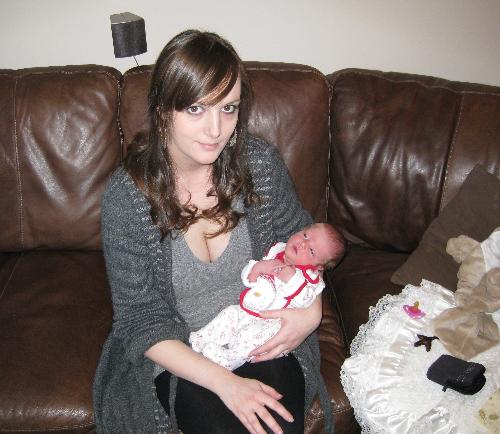 My daughters first christmas - A picture of me and my daughter on christmas day, she was exactley one week old. Exucse me looking a mess, id only given birth a few days ago