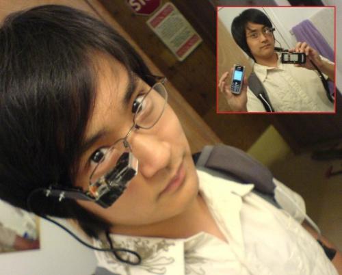 Portable Computer - This is a strange Asian man with a portable computer that he can see and use with his eye. This revolutionary technology will be the future.