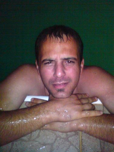 My hubby in the pool at night - It was dark..I put on the flash on my cell phone, and when he went out of the pool I barely blind him. Ha ha