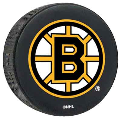 A boston bruins puck - a hockey puck with the boston bruins logo on it