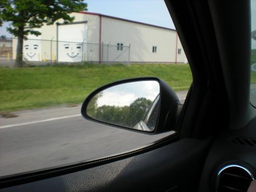Smile - I love driving by this place. Look at the smiles on the garage doors!