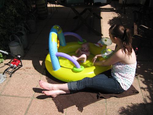 my daughter - This is a picture of my daughters very first time in her little swimming pool when she was 5 months old