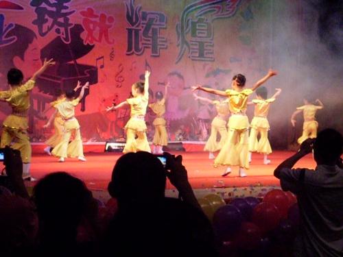 here is a photo of my small niece dancing - This is a photo taken by my brother-in-law for her daughter while she was performing with the other peers on the stage.