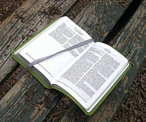 Open Bible - Image of a Bible, open to the book of Jude, on an outside wooden table