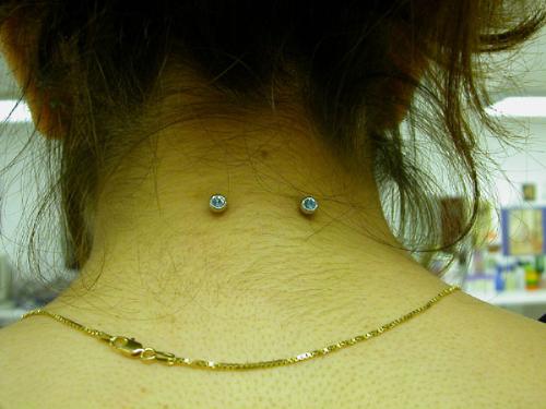 nape, neck piercing - piercing on the nape, the back of the neck