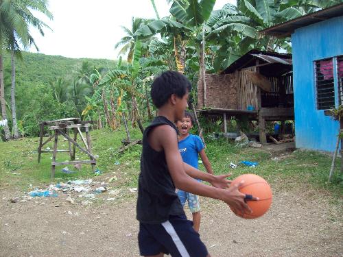 backyard basketball - kids play basketball in their backyard in one of the rural towns in Central Philippines.