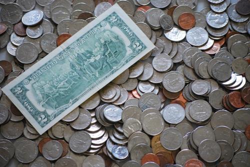 earning money - This photo is full of money, with lot of coins - dollars, quarters, dimes, nickels and penny. It also includes a 2 dollar note.