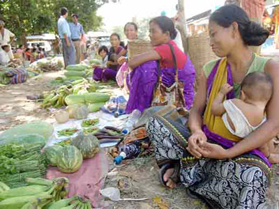 selling vegetables - Tribal women selling fresh vegetables to earn their livelihood at a roadside market in India.