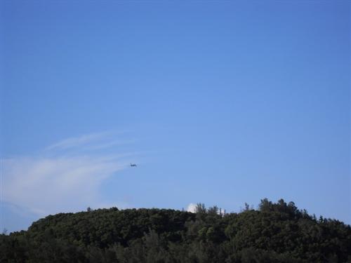 an airplane in the blue sky - Look! An airplane in the blue sky