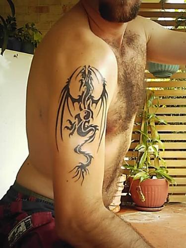 dragon tatt - i got this off the net somewhere, tweaked it a bit, and got inked, it was my first tatt
