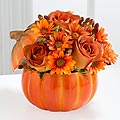 Orange flowers in a pumpkin vase - Orange floral arraignment in a orange pumpkin vase.