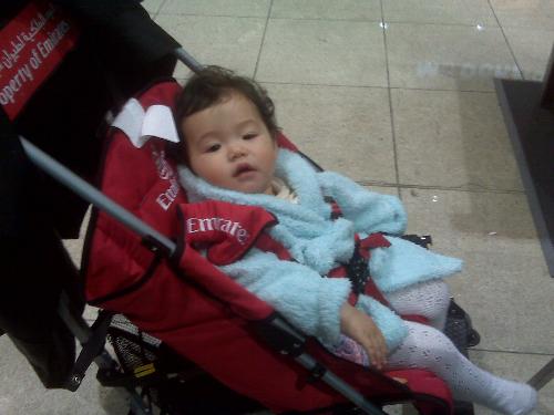 Exhausted little girl - Our poor child, had just flown 11,000 miles, must feel so terrible for such a small baby. Photo taken at Dubai International Airport.