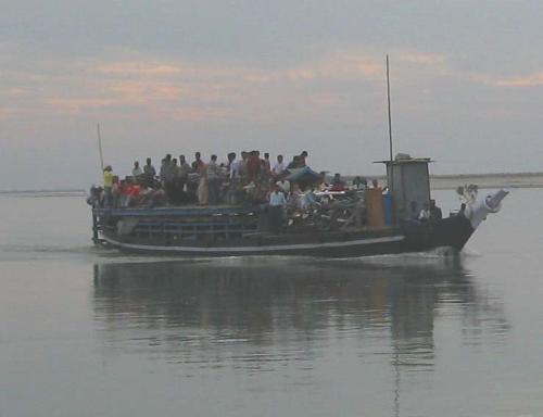 journey - People are crossing the river Brahmaputra of Assam, India.