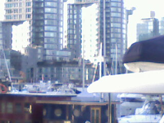 Vancouver Cityscape - You are in Coal Harbor, one of the city of Vancouver's jet setting neighborhoods. It's expensive to live here, especially if you own a yacht, although it helps you skip the mortgage, all you have to worry about is the mooring fees. On second thought, I don't know how much that is.