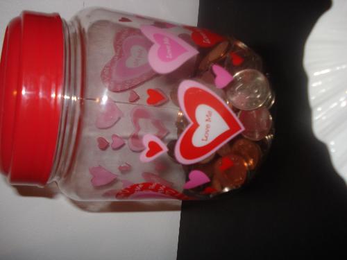 Savings - Okay i think that we all have a change bin somewhere in our room. and this is mine is has love and hearts printed all over it and i use it to but all my left over chage in it whenever i buy something and a get change i palce it in this this been orwhen i get tips from work being a cashier i place it in here. and when it gets full enough i take it to a chage sorter and get bills in return.