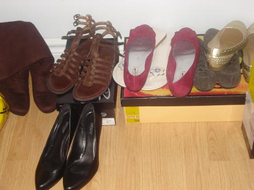 Shoes - Shoes! Shoes! and more shoes! these i bought all this year my new pair of gladiator scandles, my first ever pair of black heals, my first ever pair of flip flops because they normally hurt my feet but thses ones dont there just perfect, and i forget what else is in the photo, but it all made its way to my shoe collection this year.