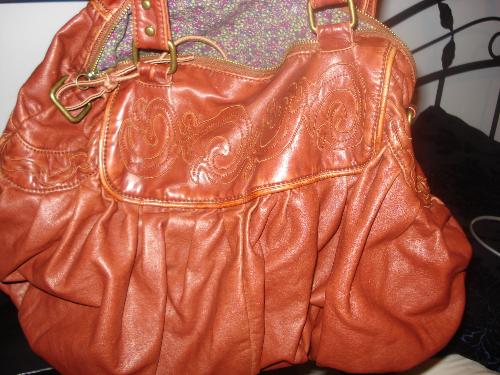 Favorite bag - i got this bag fro urban outfitters and i am in love with it, it has a removable strab that i can use for my bag and turn it into a messanger bag which is awsome! and inside the bag it is lined with a nice flowery patterned and and there is a zipper pocket, and two small open pockets, i just love this bag and it has a vintage edgy look to it which i like.