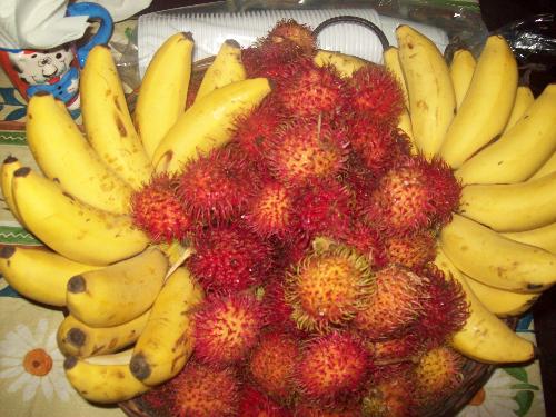 banana and rambutan - banana and rambutan fruits as table centerpiece during a birthday party. healthy and delicious.