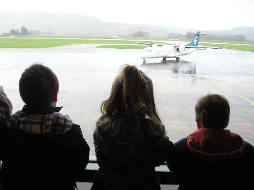 Watching a plane - Some of my grandchildren watching a plane taxi in at the airport.