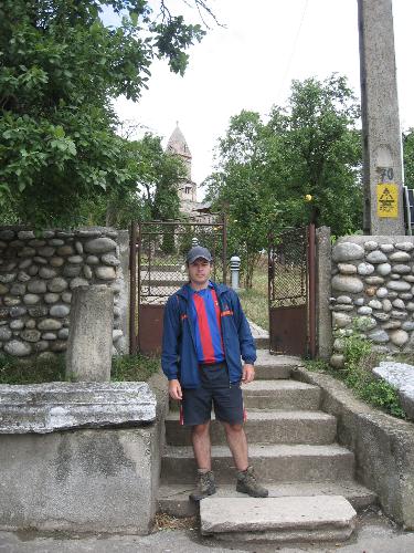 Me in front of the Densus Church - Me standing at the gate of the oldest orthodox church in Romania, the Densus Church. Picture taken in July 2008. One of the pictures I look decent in, and may be mistaken for a human.