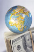 globe above dollars - everything in the world is money.