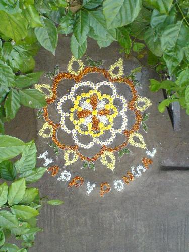 Flowers make the celebration unforgettable!! - This photo is the perfect example of how we celebrate our regional Pongal festivals. This depicts the drawings of outlines made with flowers [kolam in tamil language]. We beleive flowers make gods presence.