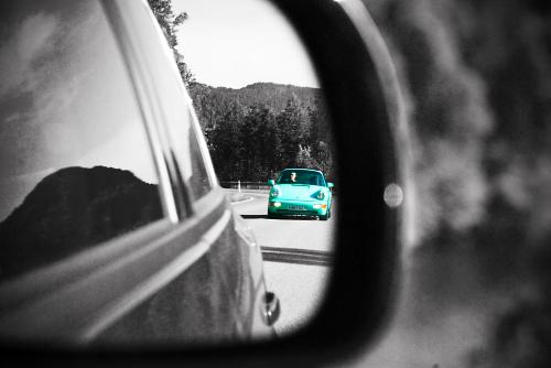 Blue Porsche in the rear mirror - My best friend and I enjoying a car trip, then this thing showed up in the mirror and the camera just happened to be within reach. Some editing was applied afterward (you can tell? d'oh!).