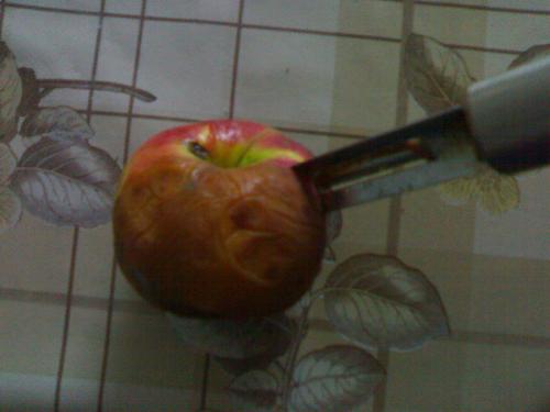 apple with a knife in it - Red apple with a little knife in it
