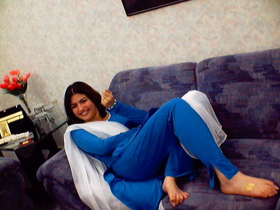 tall and sexy pakistani girl - pakistani beauty laying on sofa in blue suite.