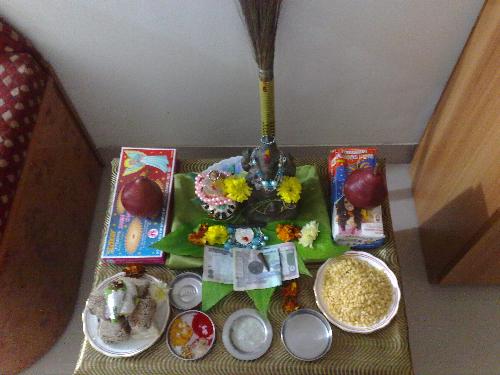 Diwali Lakshmi Pooja - The third day of the festival of Diwali is the most important day of Lakshmi-puja and is entirely devoted to the propitiation of Goddess Lakshmi. On this very day sun enters his second course and passes Libra which is represented by the balance or scale. Hence, this design of Libra is believed to have suggested the balancing of account books and their closing. Despite the fact that this day falls on an amavasya day it is regarded as the most auspicious.  The day of Lakshmi-Puja falls on the dark night of Amavasya. The strains of joyous sounds of bells and drums float from the temples as man is invoking Goddess Laxmi in a wondrous holy 'pouring-in' of his heart. All of a sudden that impenetrable darkness is pierced by innumerable rays of light for just a moment and the next moment a blaze of light descends down to earth from heaven as golden-footed Deep-Lakshmi alights on earth in all her celestial glory amidst chantings of Vedic hymns.   A sublime light of knowledge dawns upon humanity and this self enlightenment is expressed through the twinkling lamps that illuminate the palaces of thewealthy as well as the lowly abodes of the poor. It is believed that on this day Lakshmi walks through the green fields and loiters through the bye-lanes and showers her blessings on man for plenty and prosperity.   Lakshmi Pooja, or the worship of the goddess of wealth, is the main event on Diwali in North and West India. It is extremely important to keep the house spotlessly clean and pure on Diwali. Goddess Lakshmi likes cleanliness, and she will visit the cleanest house first. This is also the reason why the broom is worshiped on this day with offerings of haldi and kumkum (turmeric and vermilion). Lamps are lit in the evening to welcome the goddess. They are believed to light up Her path.   Lakshmi Puja consists of a combined puja of five deities: Ganesha is worshiped at the beginning of every auspicious act as Vighnaharta; Goddess Lakshmi is worshiped in her three forms - Mahalakshmi (the goddess of wealth and money), Mahasaraswati (the goddess of books and learning), and Mahakali; Kuber (the treasurer of the gods) is also worshiped.