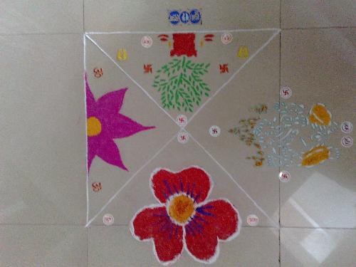 Diwali Rangoli - During Diwali, Goddess Lakshmi is believed to visit homes that are well lit, so families decorate their homes. People wear their best clothes or buy new ones, children are given presents and new year greetings are exchanged through visits or Diwali cards. Thus, a Rangoli design is created on doorsteps to welcome everybody. Rangoli exudes a pattern in color that are specific for each region.   During Diwali, in the art of floor painting, the central rangoli design is the symbolic one denoting the deity or the theme. Motifs generally created are lotus, fish, birds, snakes etc. which reflects the unity of man and beast. Most of the rangoli designs are circular exuding a sense of endlessness of time. Celestial symbols such as the sun, moon and other zodiac signs are also common themes for rangoli. Layered with symbolism is the lotus denoting Goddess Lakshmi, the unfolding of life, the heart or the wheel.   During Diwali, two interfaced triangles are created that indicates the deity of learning, Sarswati. Encircling this is a 24-petal lotus flower border, the outer circle being decorated with Lakshmi's footprints repeated in four corners. Sometimes the lotus petals are made in a triangular shape for variety. In north Bihar, Lakshmi's feet are drawn at the door, the toes pointing inwards to indicate her entrance.   Again in Andhra Pradesh there is an eight-petal lotus (ashtadal kamal) and many geometric patterns forming the lotus. In Tamil Nadu the hridaya kamalam is an eight-pointed star meaning lotus of the heart. In Maharasthra too the lotus is a basic motif and designs like shankh kamal - shell lotus and thabak which means salver is in the shape of an eight-petal lotus with straight lines elaborated with curving lines to give it the appearance of a salver. In Gujarat alone there are said to be 1001 variations of the lotus which are drawn during Diwali, the festival when Goddess Lakshmi is worshiped. Other motifs are swastikas and conch shells.   All over the southern part of India the Diwali festival is marked by gaiety and prosperity. The rangolis drawn are peripheral. Most Rangolis are basically geometric patterns formed with dots and lines to make squares, circles, swastikas, lotus, trident, fish, conch shell footprints, creepers, trees bear testimony both to individual genius and community participation and many work for days together on single design.
