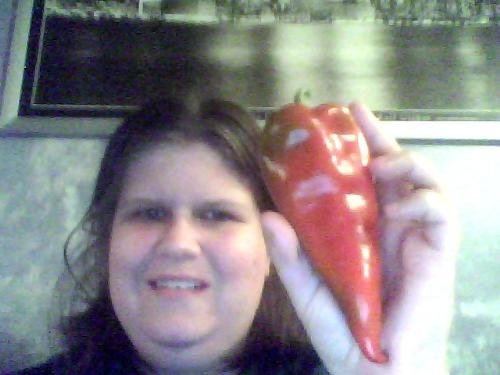 Me And My Chilli Pepper - Here I am holding up one of the hot peppers that my husband is going to stuff with cheese, coat in a breaded batter, and serve for dinner one night this week. He bought a dozen of them. Here I am holding one up for the camera.