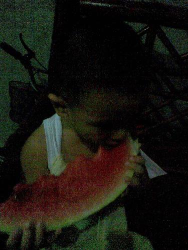 watermelon, I love! - a photo of a kid eating a slice of watermelon...