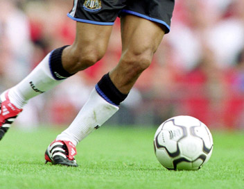 Football - Player dribbling with football (Waist down)