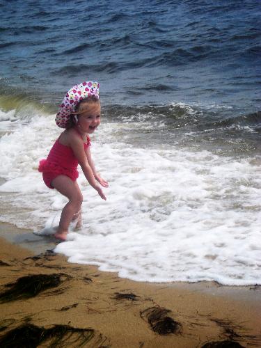 Girl on beach - Whitepoint Beach in Bluewater Bay, Florida. Girl in pink Gymboree swimsuit and Gymboree ladybug hat.