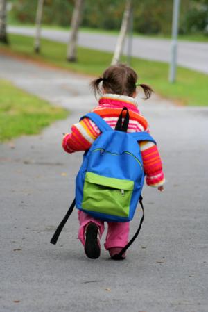 kids walk to school alone - a litte girl walks to school alone.