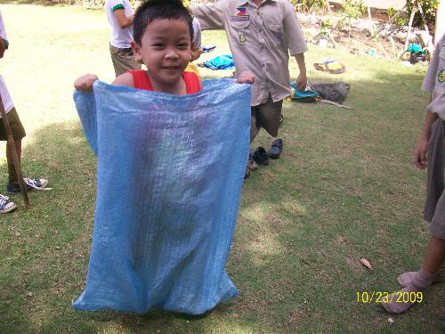 child enjoying play - child happy to have enjoyed sack race, philippines