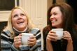 Friends coffee break - Two friends having cup of coffee in their hands and chatting about their past days in college and school. Memorable sweet memories isn't it ?