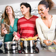 Friends preparing dinner - These are family friends preparing dinner and enjoying party in the night.Their families are also with them.