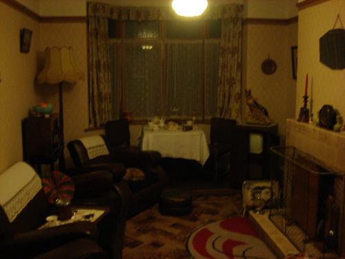 a front room in 1950s - That is a living room of a semi-detached suburban house belonging to a work-class family at the time of Queen Elizabeth’s coronation in 1953. There you can see furniture of 1930s, 40s and 50s. Last but not least you can see at the time a television set already became a new form of entertainment, displacing the hearth as the focal point for the family. It is said that at the time many people purchased television sets especially to watch Queen Elizabeth’s coronation.