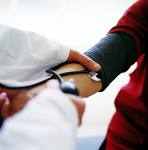health - a doctor checking the blood pressure
