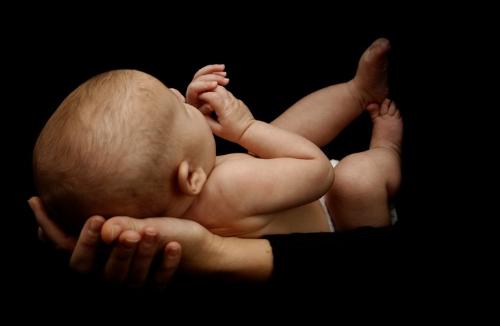 Life - This babe in the palms of her mother depends totally for her life on its mother. What future holds no one knows.