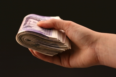 British twenty pound notes in a hand - Picture of British pound notes in a hand